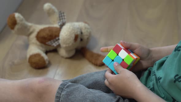 Close-up of a boy solve a rubiks cube