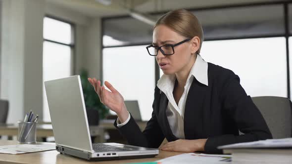 Female Employee Reading Bad News on Email, Angrily Closing Laptop, Dismissal