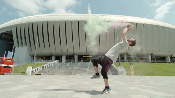 Man doing a back flip and throwing colorful powder, Ultra Slow Motion