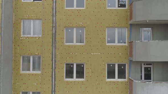 Aerial view oа Construction of façade of house. Insulation and plastering 18