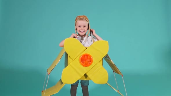 Emotional Boy in Cardboard Airplane