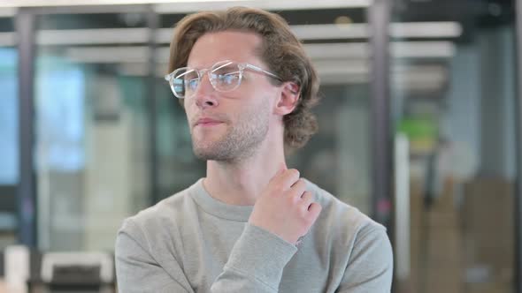 Portrait of Pensive Young Businessman Thinking