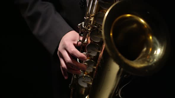 Musician Plays Closeup on the Saxophone Valves in Darkness