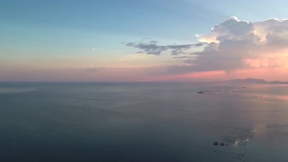 Sunset in Mesologgi Greece. Aerial view of the sunset behind clouds and sea horizon.