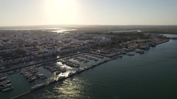 Aerial View of the Coastal village of Vila Real Santo Antonio and marina, Bright sunlight