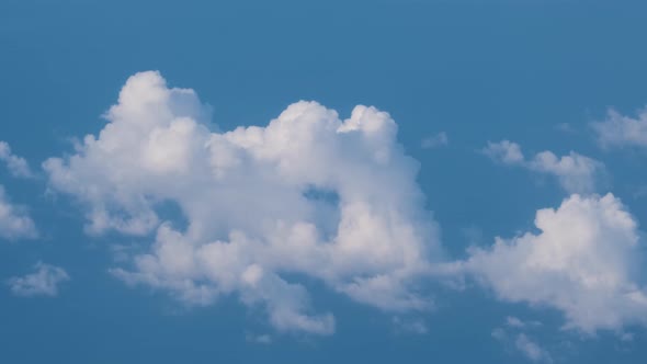 Aerial View From Airplane Window at High Altitude of Earth Covered with Puffy Cumulus Clouds Forming