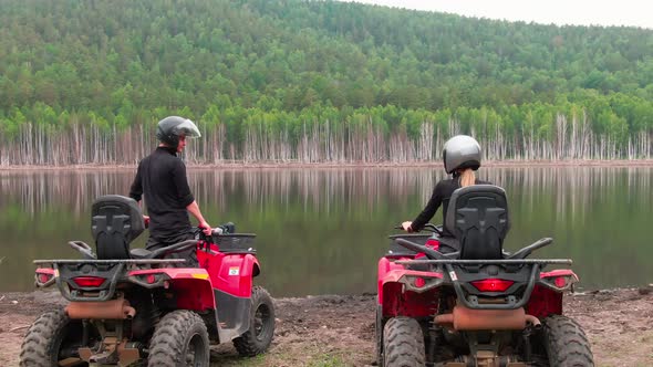 Aerial of Couple on Quad Bikes by Lake