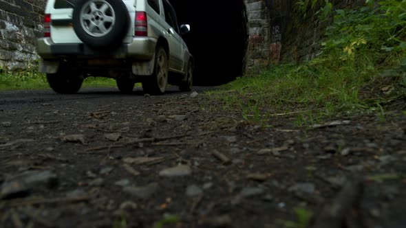 The Car Drives Into a Tunnel in the Forest