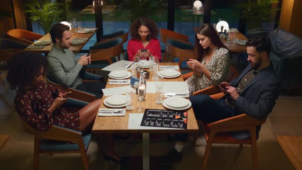 Multiracial Group Checking Phone Device in Cafe