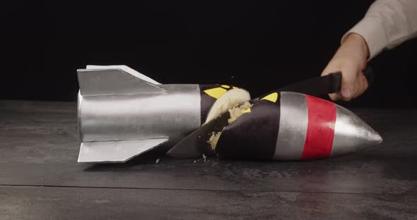 Machete Cuts A Cake In The Shape Of A Nuclear Missile