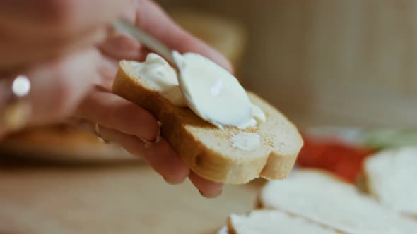 Hands Spread Mayonnaise on Bread Butter