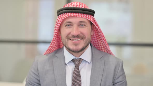 Portrait of Attractive Middle Aged Arab Businessman Smiling at Camera