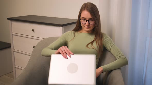 Smiling Woman in Glasses Start Using Laptop Browsing Surfing Internet Social Media Studying or