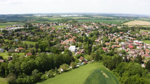 Aerial Drone Shot  a Picturesque Town Surrounded By Fields in a Rural Area  Drone Flies Backward