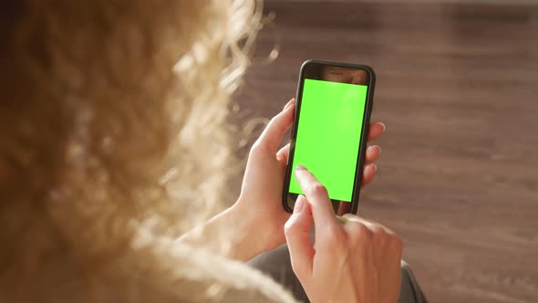 Woman Taping on the Smart Phone with Green Screen Chroma Key