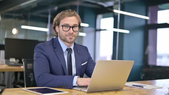 Cheerful Businessman Pointing Finger and Inviting