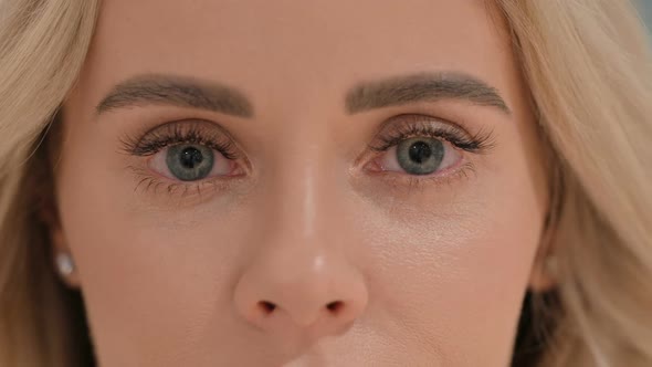 Close Up of Blinking Eyes of Young Woman Looking at Camera