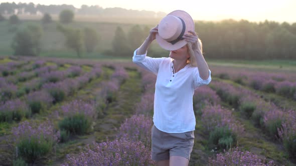 Drone Video of Free and Happy Young Woman Run in Pink and Purple Lavender Fields at Sunset