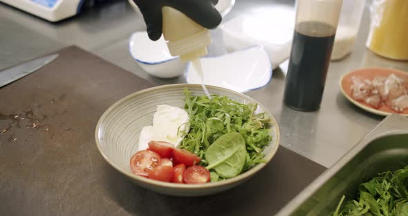 Tasty Salad Mix with Oil in the Kitchen in the Restaurant