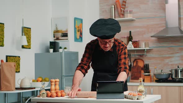 Grandfather Learning to Cook Home Pizza