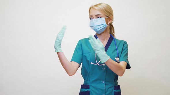 Medical Doctor Nurse Woman Wearing Protective Mask and Latex Gloves - Showing at Empty Copy Space