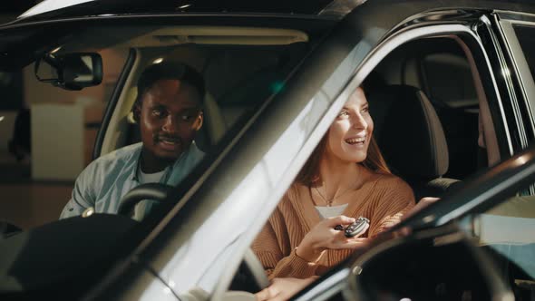 Salesman Giving Keys From New Auto