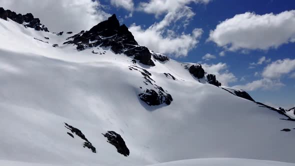 Timelapse with clouds passing over the snow covered peak of Perito Moreno Hill, El Bolsón, Patagonia