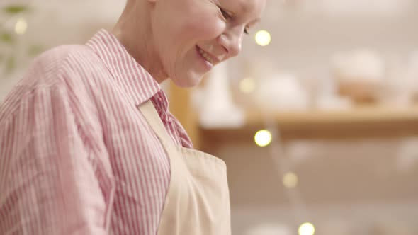 Happy Senior Caucasian Lady Making Clay Bowl in Workshop