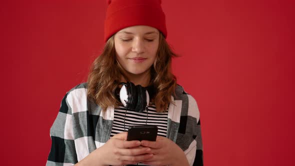 Girl Teenager Using Smartphone on Red Background