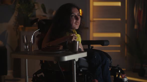 Woman in a Wheelchair Watching TV Show