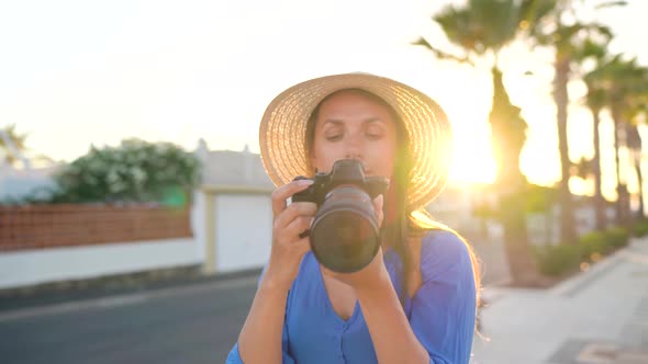 Photographer Tourist Woman Taking Photos with Camera in a Beautiful Tropical Landscape at Sunset