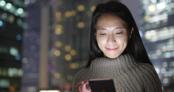 Woman use of smart phone at night