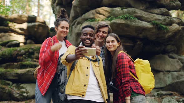 Funny Young People Happy Friends Are Taking Selfie in Wood with Mossy Rocks in Background, African