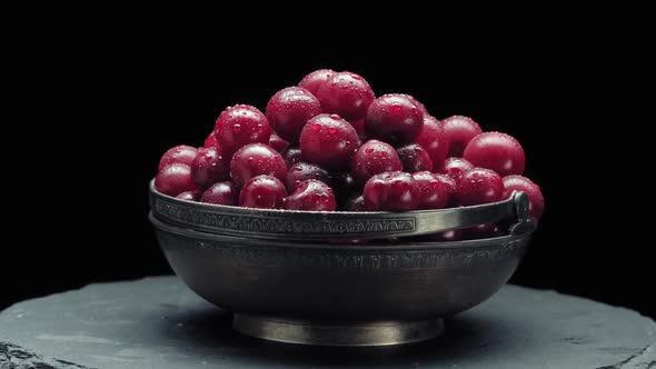 Ripe Fresh Cherry in Vintage Metal Bowl Rotation on Black Gastronomy Concept Organic Food