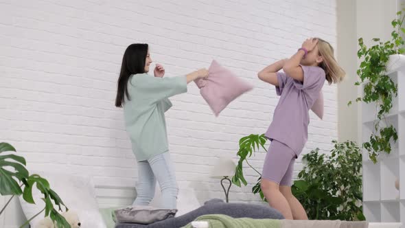 Young Girls Dancing on the Bed at Home