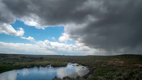 Time lapse of summer rainstorm moving across the desert next to river