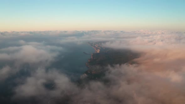 Aerial video over low clouds and morning fog