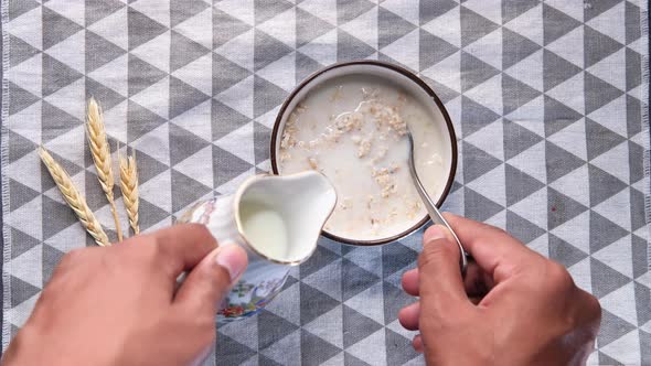 High Angle View of Man Hand Making Oats Flakes 