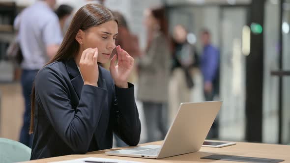Stressed Businesswoman with Headache at Work