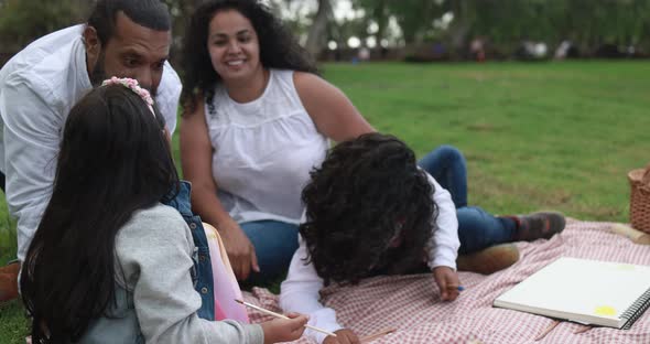 Indian parents having fun at city park playing with their children