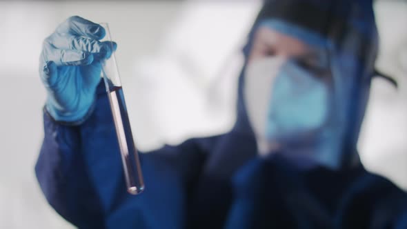 Female Scientist Shaking Optical Glass Test Tube Cuvettes. Coronavirus Research, Vaccine Development