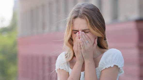 Closeup Allergic Young Woman in Summer Dress Sneezing with Hands in Front of Face