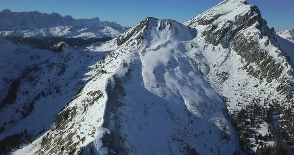 Aerial drone view of snow covered mountains in the winter