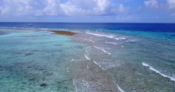 Natural fly over clean view of a sandy white paradise beach and turquoise sea background in vibrant 