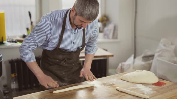 Handsome Baker Kneads Dough and Making Bread