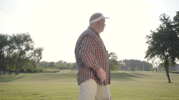 Portrait Successful Mature Golfer Golfing on Beautiful Course