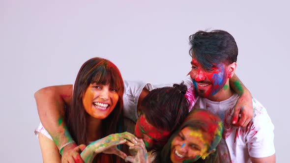 Four Happy Best Friends Having Great Traditional Holi Time Together in White Background Studio