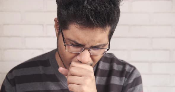 Young Asian Man Coughing and Sneezes Close Up