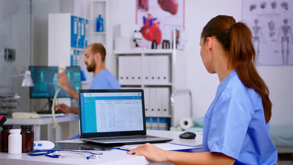 Medical Doctor Nurse Holding and Analysing Radiography