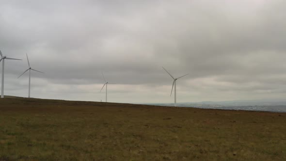 Slow spinning wind turbines shot from a drone